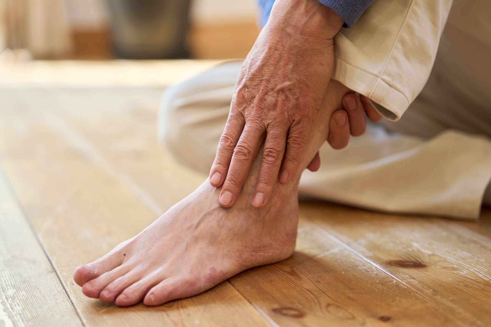 Home 7 Senior Asian man holding his painful ankle